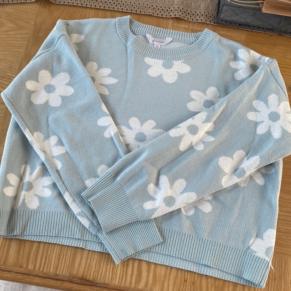 Green sweater with white flowers
